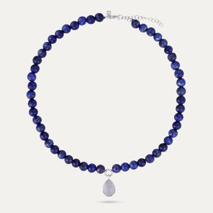 Necklace with blue beads and a silver pendant on a white background