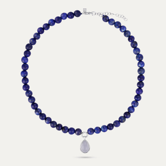 Necklace with blue beads and a silver pendant on a white background
