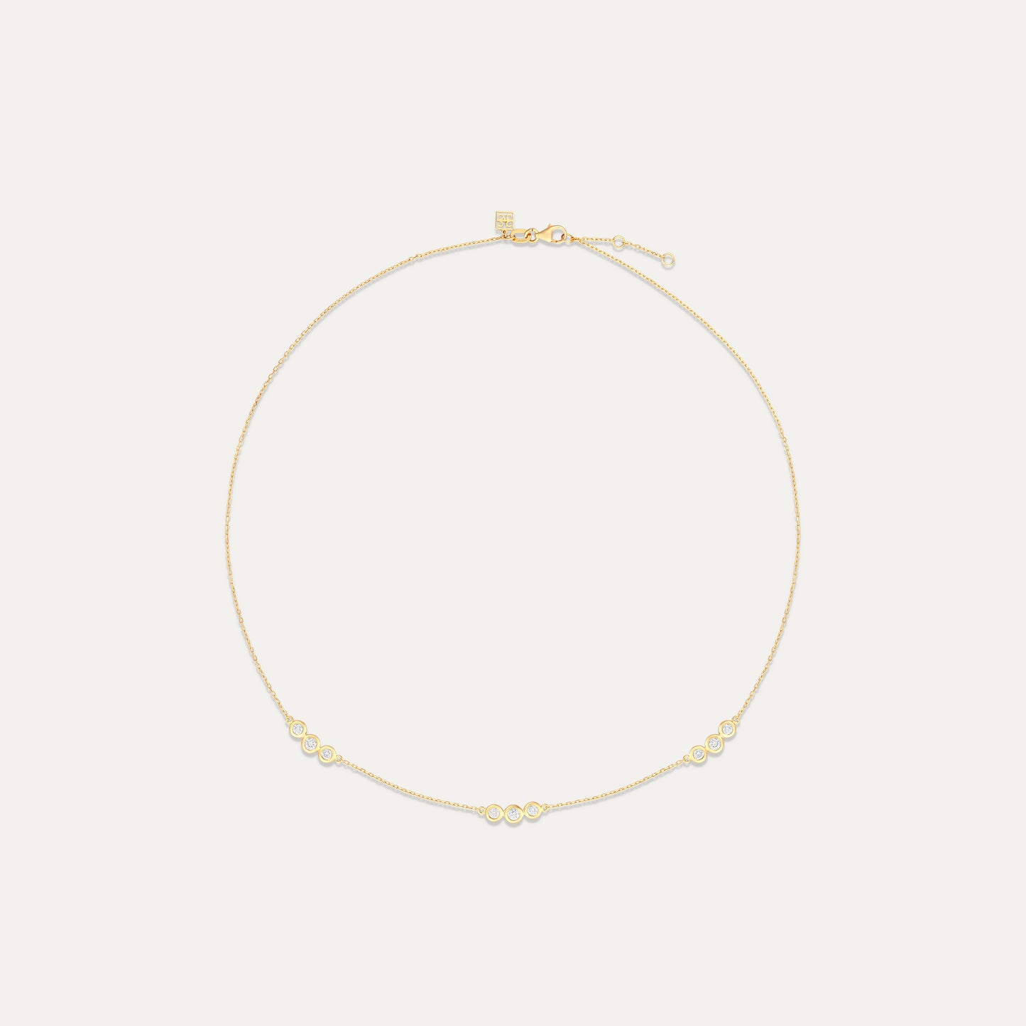 Gold necklace on a light beige background
