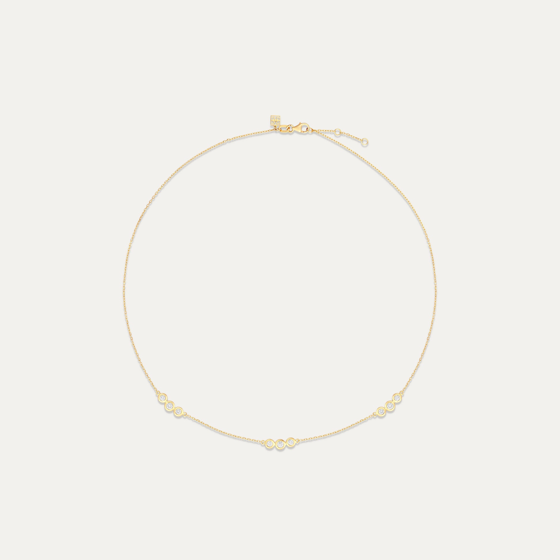 Gold necklace on a light beige background