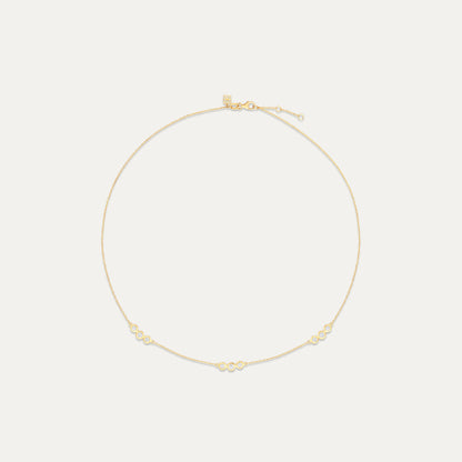 Gold necklace on a light beige background