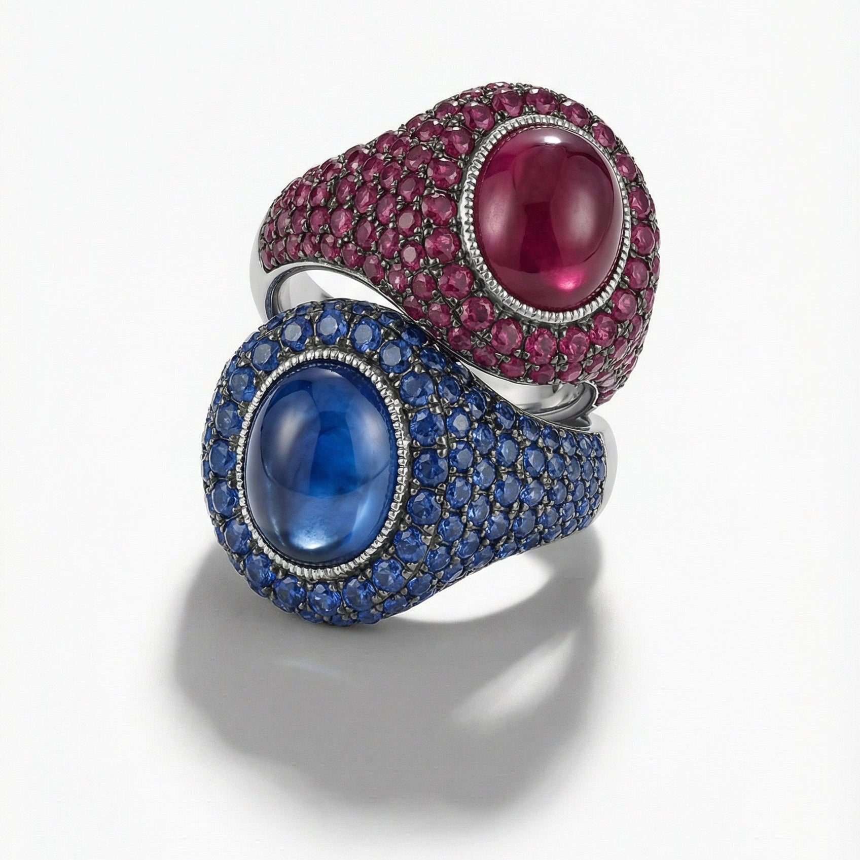 Two rings with gemstones on a white background