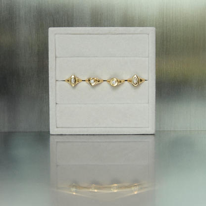 Gold bracelet on a white jewelry box with a blurred background