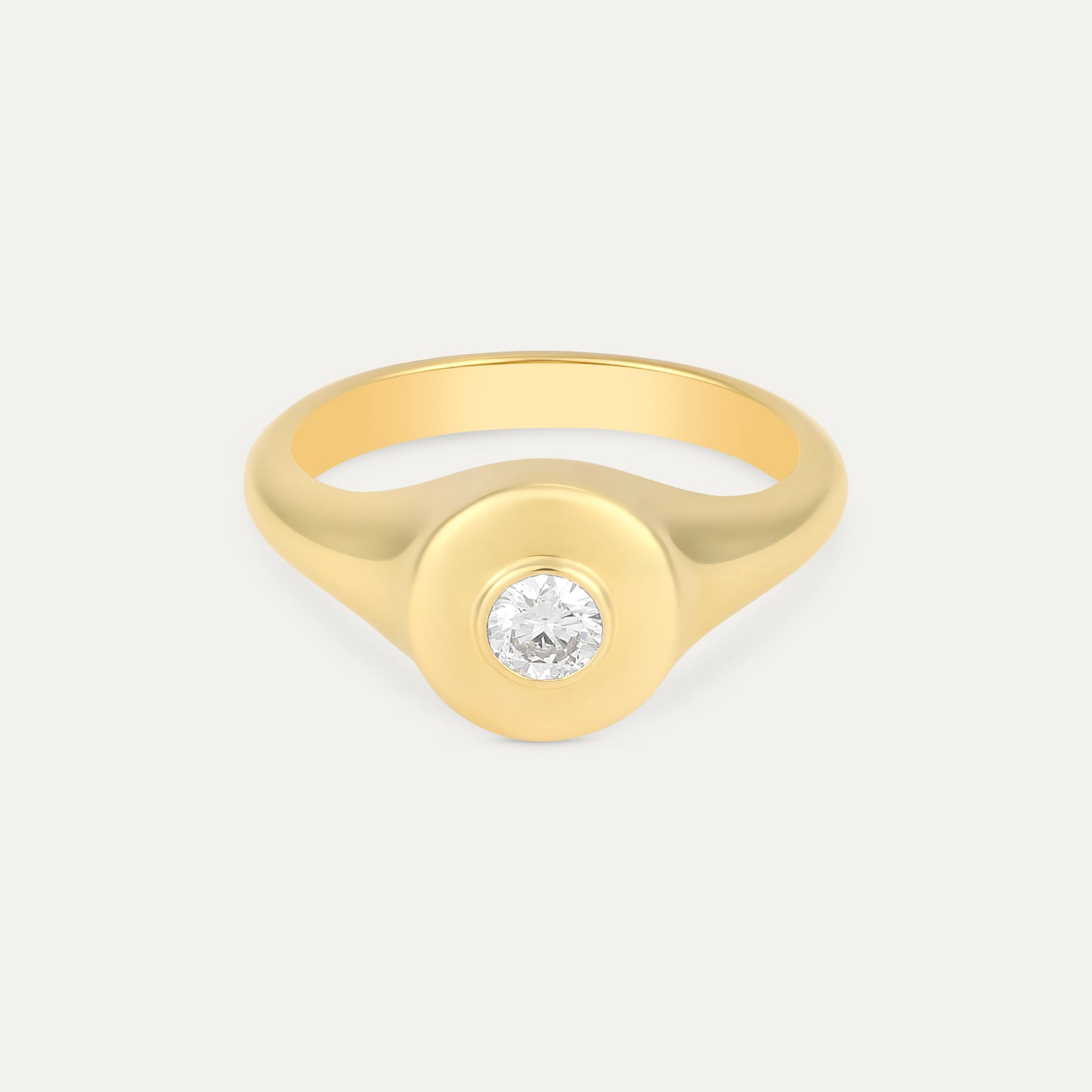 Gold ring with a diamond on a light gray background