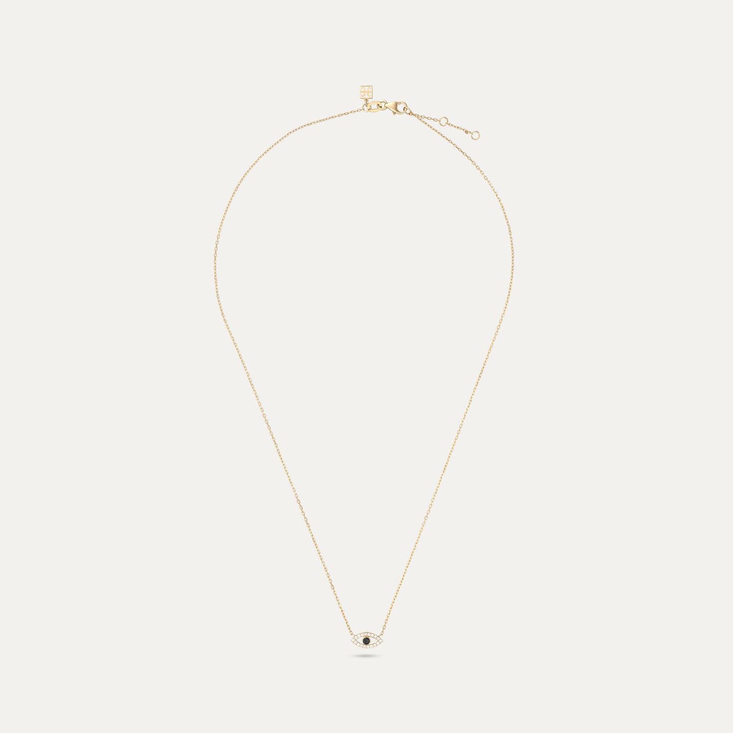 Gold necklace with a small pendant on a white background
