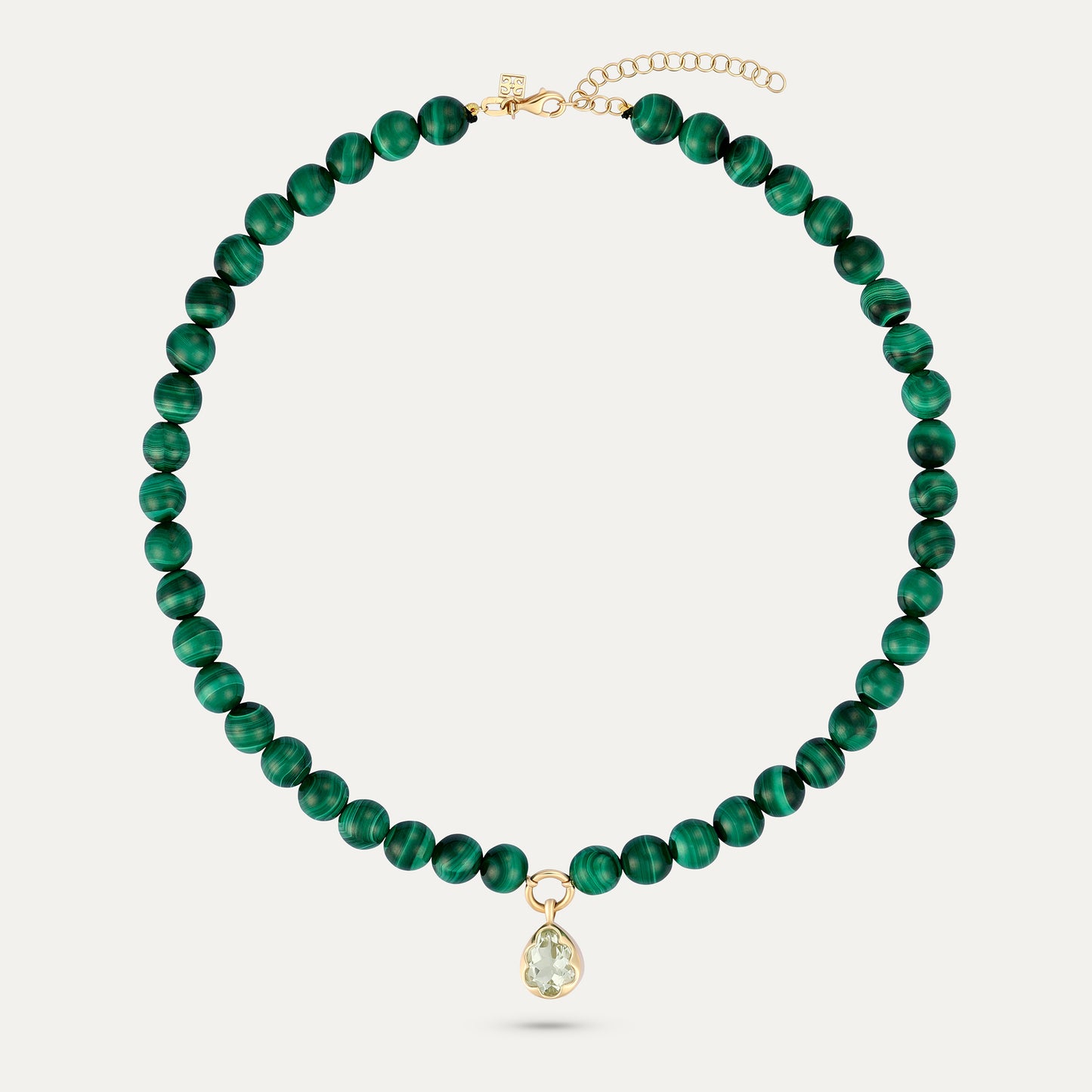 Green beaded necklace with a gold clasp on a white background